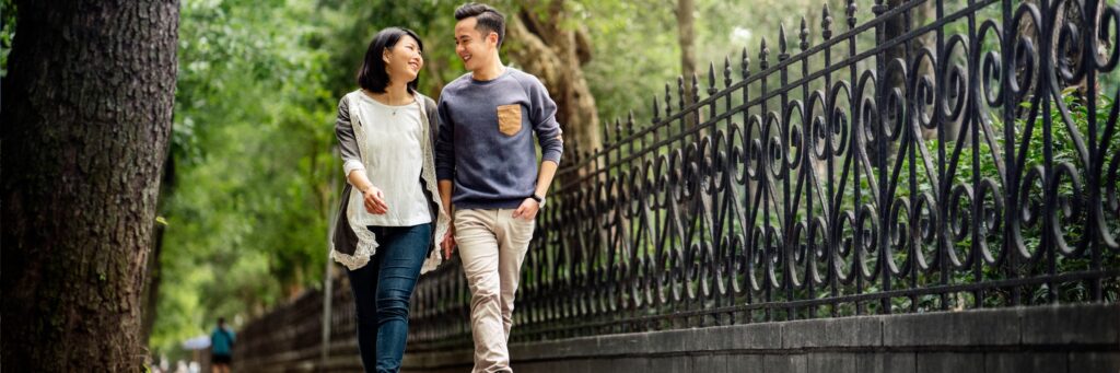 Couple walking in city park